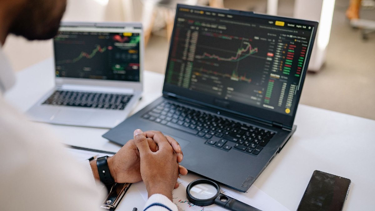 Trader analyzing stock charts with calm emotional discipline