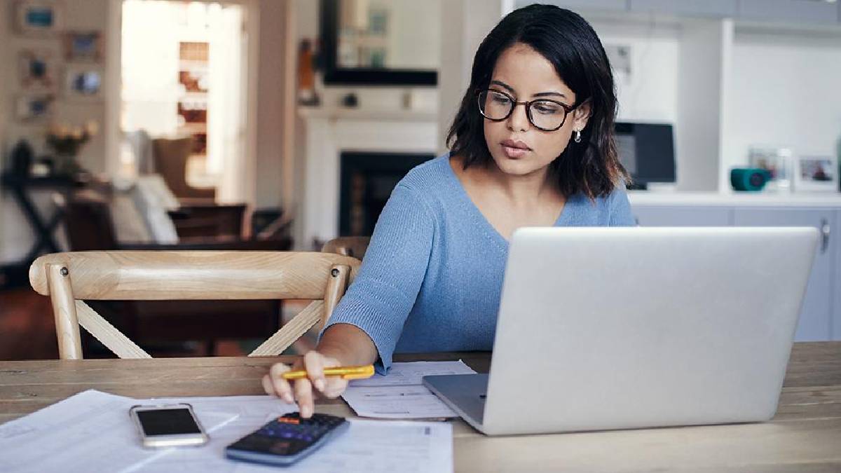 Freelancer financial planning with laptop and calculator