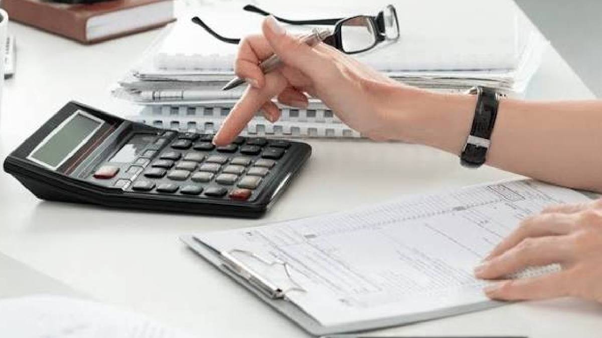 Person calculating monthly expenses