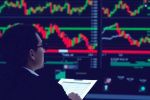 Trader analyzing stock market losses on multiple screens